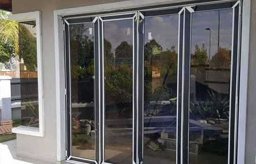 Aluminium & Glass Work Services - A large aluminium-framed windows, showcasing the company's exceptional glass installation expertise in enhancing contemporary design in home renovations.